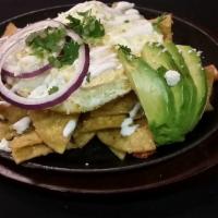 Chilaquiles · Crispy fried tortilla tossed in our green or red sauce. Topped with two fried eggs, fresh av...
