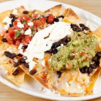 Nachos · Refried beans, pico de gallo, jalapeños, guacamole, sour cream, melted cheese, and your choi...