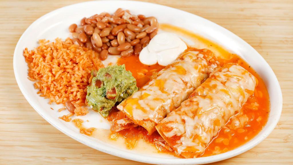 Enchiladas · Shredded chicken or beef rolled in corn tortilla. Served with melted cheese, rice, beans, lettuce, and tomatoes.