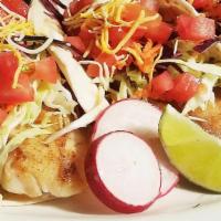 Fish Tacos · Broiled tilapia over flour tortilla. Topped with mayonnaise, cabbage, carrot, cilantro, and ...