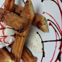 Churros · Crispy churros filled with cream coated on cinnamon sugar, chocolate sauce and served with v...