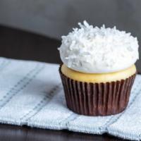 Coconut · Coconut cake with vanilla buttercream frosting, topped with shaved coconut.