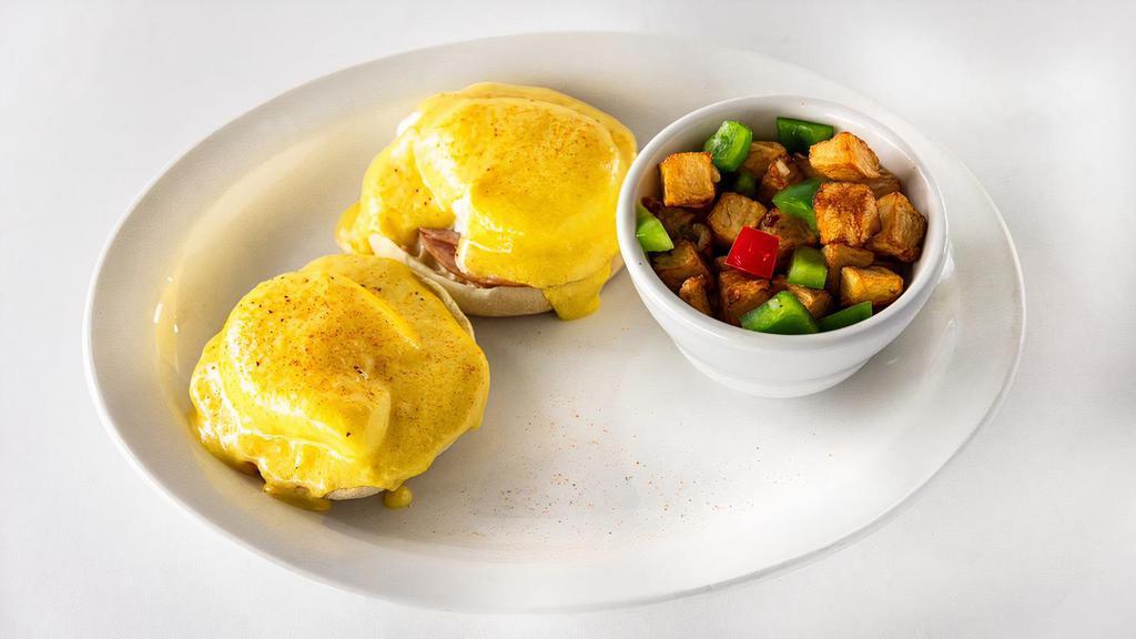Melina'S Benedict · Two buttermilk biscuits, topped with two poached eggs, hollandaise, served with hash potatoes, toasted English muffin, Canadian bacon.