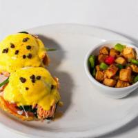 Smoked Salmon Benedict · Two buttermilk biscuits, topped with two poached eggs, hollandaise, served with hash potatoe...