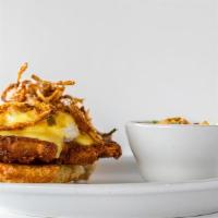 Herb Fried Chicken Benedict · Two buttermilk biscuits, topped with two poached eggs, hollandaise, served with hash potatoe...