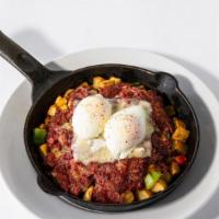 Corned Beef Hash · Tossed with crispy hash potatoes, poached eggs, corned beef, caramelized onions, Swiss cheese.