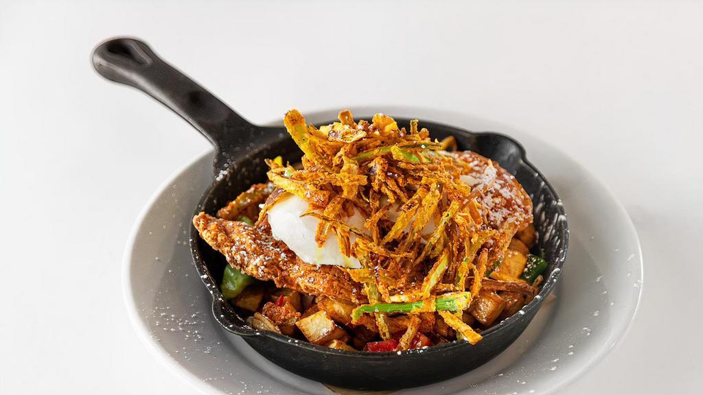 Herb Fried Chicken Hash · Tossed with crispy hash potatoes, herb fried chicken, two poached eggs, fried leeks, warm maple reduction.