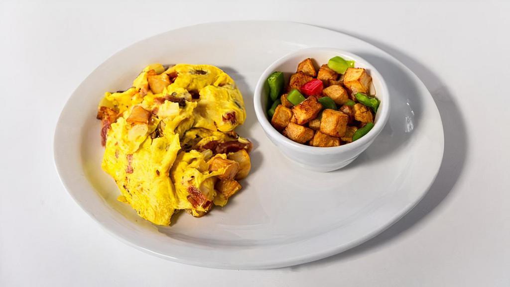 Thick Cut Bacon Scrambler · Potatoes, onions, Swiss cheese, served with hash potatoes.