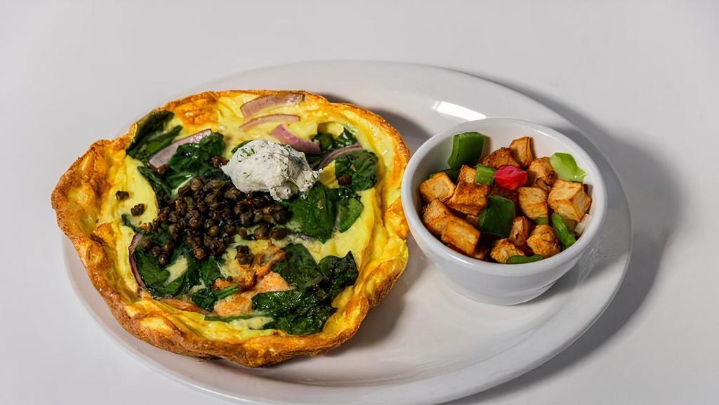 Smoke Salmon Frittata · House smoked salmon, wilted spinach, red onions, dill mascarpone, crispy capers, served with hash potatoes.