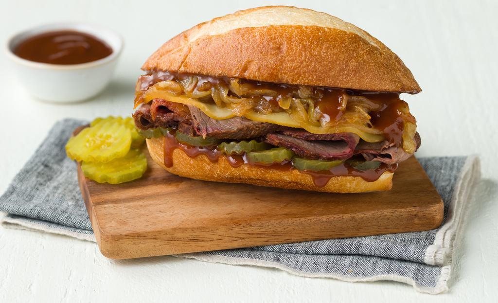 Smokehouse Brisket Sandwich · Brisket, Red Onion, BBQ Sauce & Pickles.