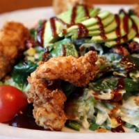 Buttermilk Chicken Salad · Buttermilk-fried chicken, fresh greens, tomatoes, avocado, sweet corn, bacon, BBQ sauce, and...