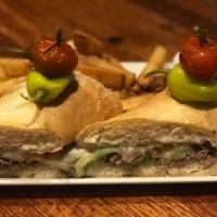 Philadelphia Steak Sandwich · Shaved beef, caramelized onions, peppers, mozzarella cheese, toasted pub roll. Served with f...