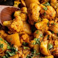 Aloo Gobi · (Vegan) (GF) Cauliflower and potatoes cooked  With ginger, tomatoes and spices