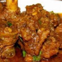 Goat Curry · Bone in. Goat meat stewed in onion and tomato-based sauce, flavored with ginger, garlic, chi...