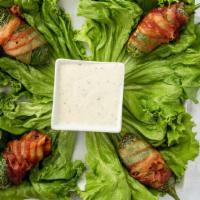 Picositos · Gluten-free. Grilled jalapenos stuffed with shrimp, cream cheese and wrapped with bacon. Ser...