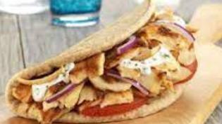 Stackd Gyro · Served with lettuce, tomatoes, grilled onions, grilled peppers, feta cheese, tzatziki sauce, rolled with pita.