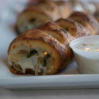 Supreme Stromboli · Our pizza dough wrapped around loads of cheese, pepperoni, Beef, black olives, red onions. S...