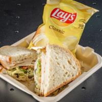 The Big T · This sliced turkey piled high with cheese, lettuce, tomato, onion, olive, black pepper and y...