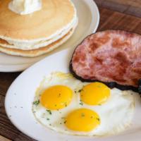 Slam Combo · Three pancakes and three eggs served with choice of ham, sausage or bacon.