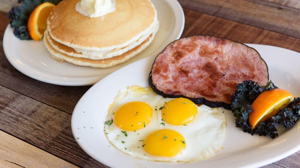 Slam Combo · Three pancakes and three eggs served with choice of ham, sausage or bacon.