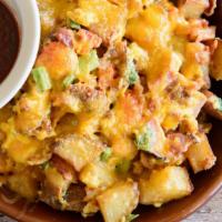 Eggscellent Potatoes Scrambled · Home potatoes, bacon, ham, tomatoes and green onions scrambled with eggs, topped with chedda...