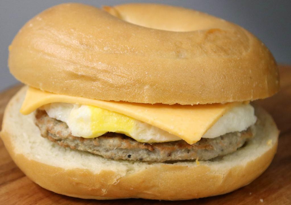 Sausage Egg & Cheese On A Plain Bagel · Farm-fresh egg, natural Tillamook cheese, and 65% lean Jonesfarm sausage patty on a plain bagel.
PLEASE NOTE:  THESE ARE PRE-MADE AND DELIVERED FROM THE BAKERY SO WE CANNOT CHANGE ANY OF THE INGREDIENTS.  IF YOU WOULD LIKE SOMETHING REMOVED, YOU CAN CHOOSE TO HEAT IT YOURSELF SO YOU MAY REMOVE ANY OF THE UNWANTED INGREDIENTS.