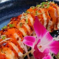 Lion King Roll* · Baked California roll topped with salmon, masago, green onion, and sweet soy glaze.