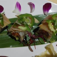 Cancun Roll* · Spicy tuna, cilantro, cucumber, and avocado topped with seared albacore, jalapeño, green oni...