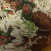 Fish Tacos · Two pieces. Wild caught cod on a corn tortilla with dill ranch covered in slaw and pico de g...