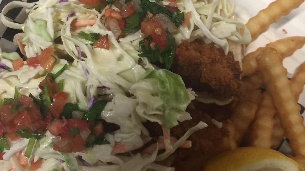 Fish Tacos · Two pieces. Wild caught cod on a corn tortilla with dill ranch covered in slaw and pico de gallo. Baskets come with coleslaw and tots.
