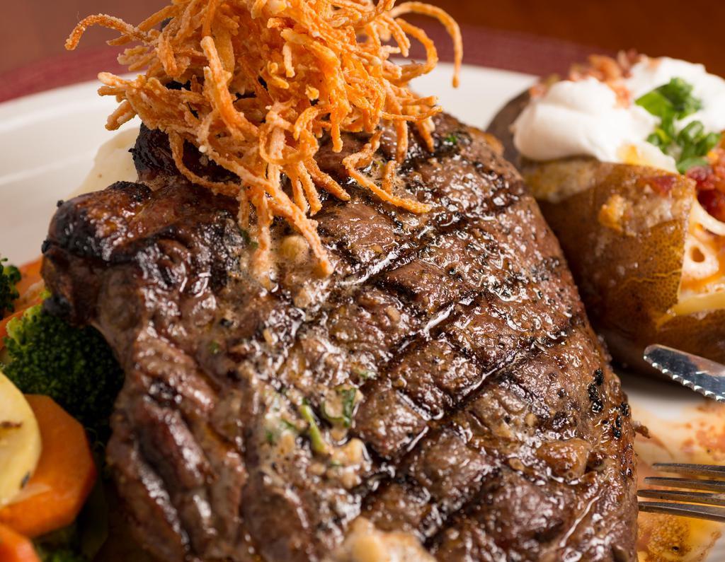 Ribeye · 16 oz. ribeye, spiced garlic butter, garlic mashed potatoes, grilled vegetables, onion strings.

This item may be served raw or undercooked or may contain undercooked ingredients. Consuming raw or undercooked meats, poultry, seafood, shellfish, or eggs may increase your risk of food-borne illness.