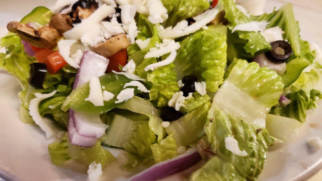 House Salad · Crisp romaine, spring mix, tomatoes, onions, mozzarella, black olives, green peppers, mushrooms