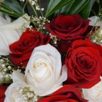 Red And White Dozen Roses · Fresh beautiful red and white roses paired with green foliage.