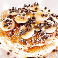 Banana Chip Pancakes · Daily Drip's three buttermilk pancakes served with fresh bananas, chocolate chips, maple syr...