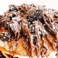 Obsessed Oreo Pancakes · Daily Drip's three buttermilk pancakes served with oreos, chocolate chips, nutella, maple sy...