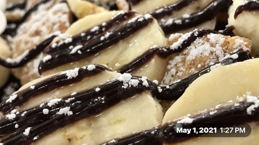 Sweet & Crunchy Crepe · Vanilla bean gelato, nutella spread, banana, chocolate chips, chocolate drizzle, cinnamon flakes, powdered sugar, whipped cream on a freshly made crepe