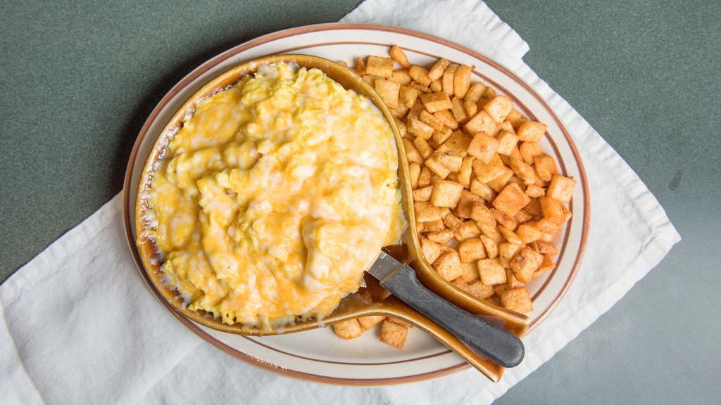 Sunrise Mountain · A fluffy breakfast croissant served open faced and piled high with four eggs scrambled with your choice of ham, bacon, or sausage (link, patty, or turkey), then topped with melted cheddar and jack cheese. Served with a side of habla diablo seasoned potatoes.