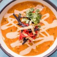 Chicken Tortilla Soup · Chicken, tomatoes, green chilies, corn, chopped onion, southwest crema, and topped with tort...