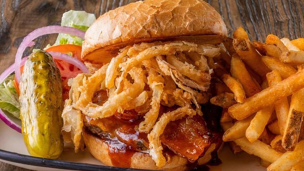 Cowboy Burger · 100% fresh ground chuck loaded with Double Barrel BBQ sauce with cheddar cheese, applewood smoked bacon and mayo. Crowned with Cajun onion straws.
CAL. 1410 - 1680