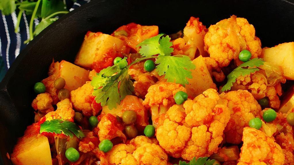 Aloo Gobi Matar · Cauliflower, potatoes, and peas cooked in a delicate blend of herbs with spices. Vegan, vegetarian and gluten-free.