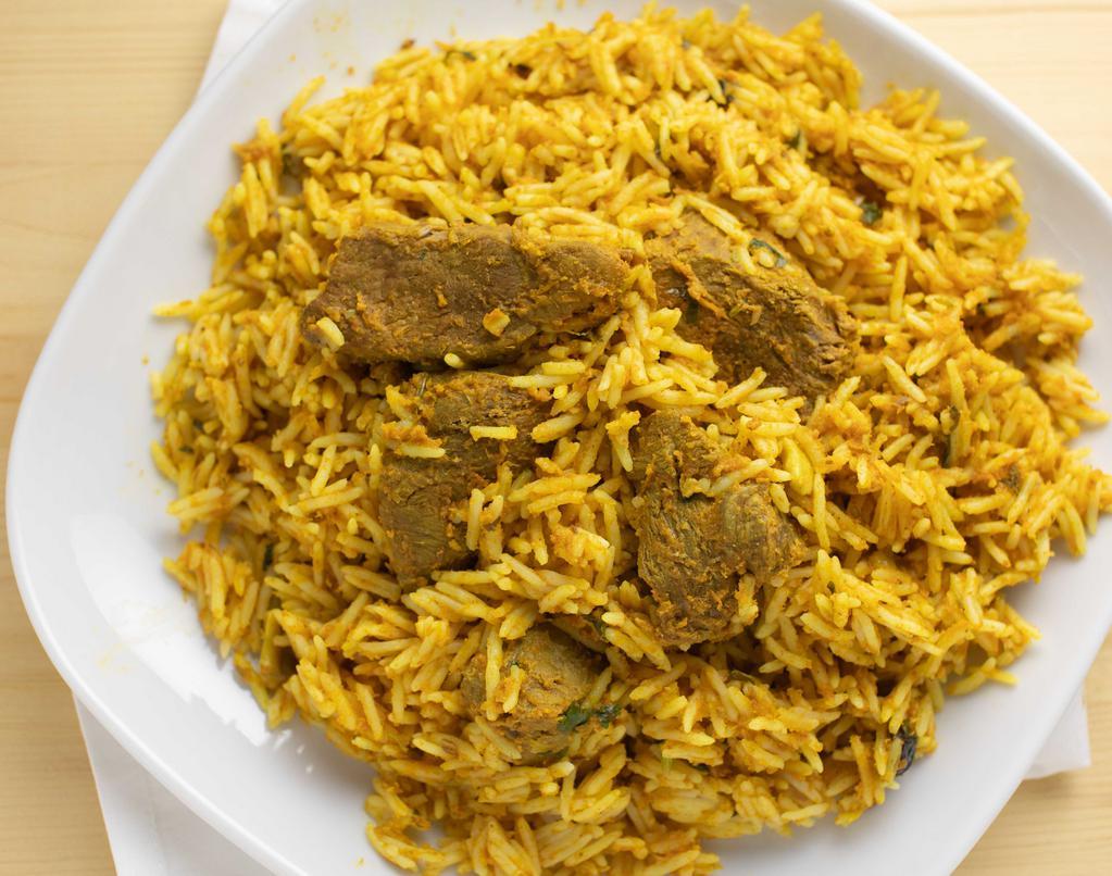 The Delhi Lamb Biryani · Basmati rice cooked with lamb in mild spices, raisins, and cashews.