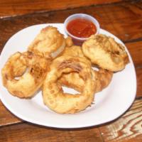 Dark Beer-Battered · Beer battered onion rings served with ketchup