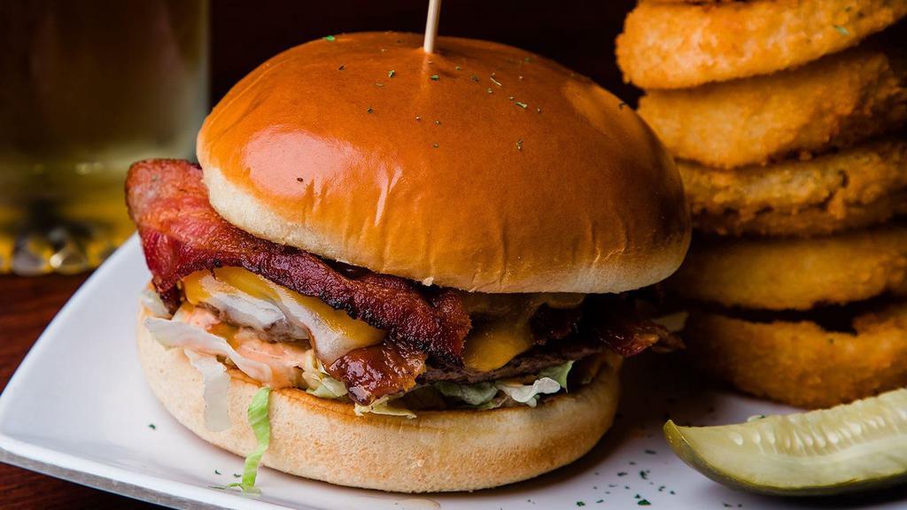 Rochester’S Famous Bunker Burger* · 1/3 lb. Burger topped with melted cheddar & swiss cheeses, bacon, tomato, lettuce & rochester’s “secret dressing”.
