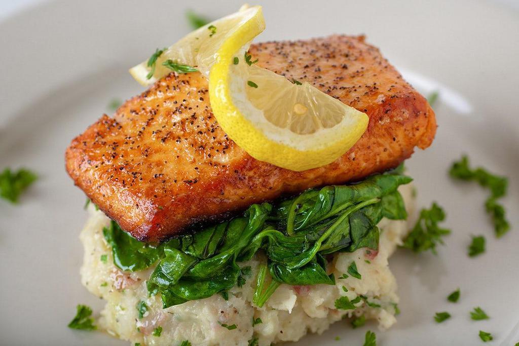 Wood-Fired Norwegian Salmon* · wood-fired norwegian salmon, garlic-herb smashed potatoes, wilted spinach