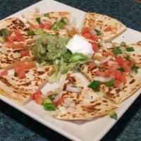 Quesadilla · Crispy flour tortillas stuffed with cheddar cheese, jack cheese, green onions, tomatoes, and...