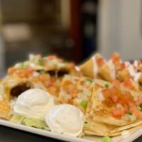 Combo Appetizer · Bean nachos, cheese quesadilla, and a deep-fried chicken burrito. Served with tomatoes, gree...