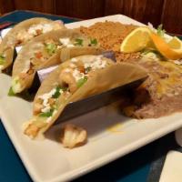 Tacos El Patron · Prawns sautéed with onions, bell peppers, mushrooms, and melted cheese. Served in soft corn ...