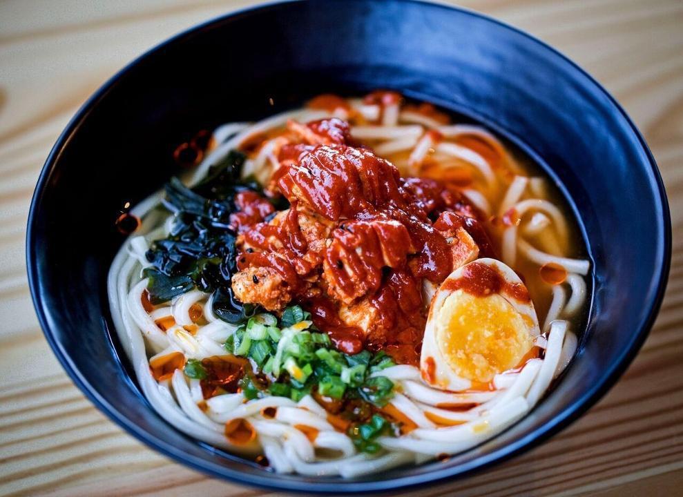 Spicy Udon · Thick Japanese udon noodles, spicy. chicken, seaweed, scallions & soft boiled half egg in soy broth