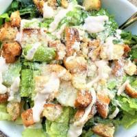 Classic Caesar Salad · Chopped Romaine Lettuce topped with our Homemade Croutons, Cherry Tomatoes, Parmesan, and ou...