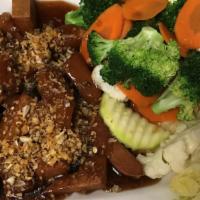 Garlic Sensation · Veg protein sauteed in garlicky brown sauce, topped with crispy garlic. Served with steamed ...